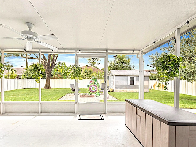 unfurnished sunroom featuring a wealth of natural light and ceiling fan