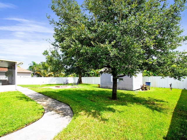 222 SW Starfish Ave, Port Saint Lucie, FL 34984 - view of yard with an outdoor structure, a storage unit, and an outdoor fire pit