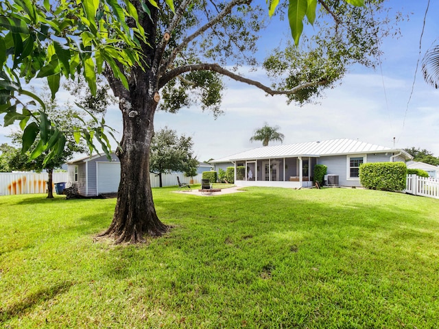 view of yard featuring a storage unit, a sunroom, and central air condition unit