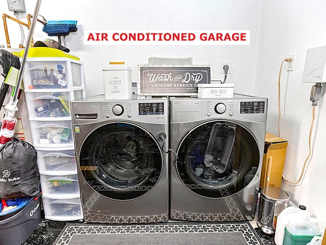 clothes washing area with washing machine and dryer