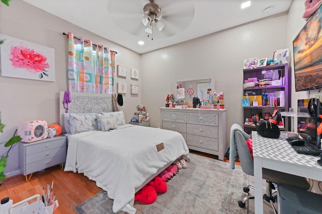 bedroom with ceiling fan and hardwood / wood-style floors