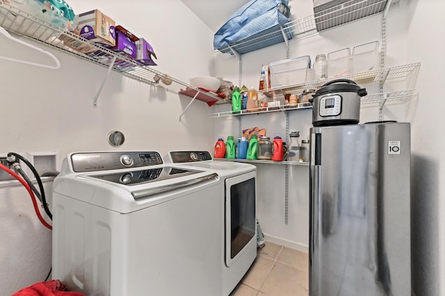 clothes washing area featuring separate washer and dryer and light tile patterned flooring