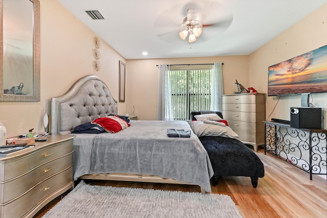 bedroom featuring access to outside, ceiling fan, and wood-type flooring