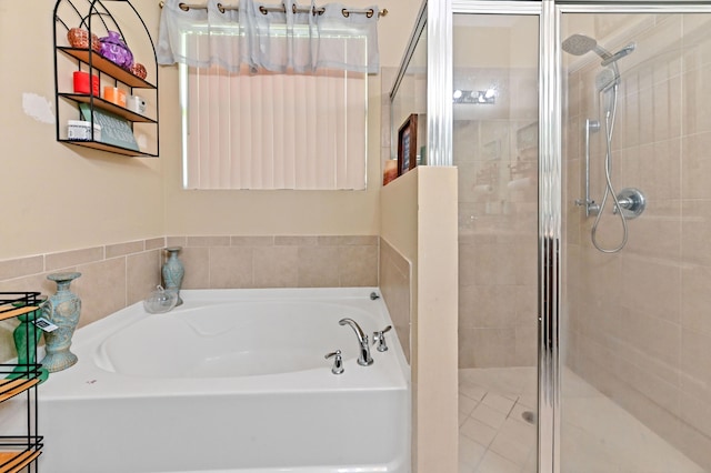 bathroom with separate shower and tub