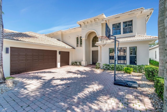 16106 Rosecroft Ter, Delray Beach, FL 33446 - mediterranean / spanish-style house featuring a garage, stucco siding, a tile roof, and decorative driveway