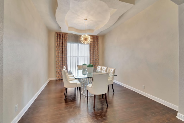 16106 Rosecroft Ter, Delray Beach, FL 33446 - dining room featuring a tray ceiling, baseboards, a notable chandelier, and dark wood-style floors