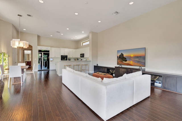 16106 Rosecroft Ter, Delray Beach, FL 33446 - living room with a towering ceiling, dark wood-style floors, visible vents, and recessed lighting