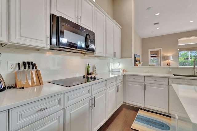 16106 Rosecroft Ter, Delray Beach, FL 33446 - kitchen with visible vents, a sink, white cabinetry, black appliances, and dark wood-type flooring