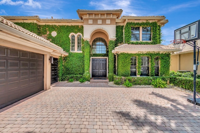 mediterranean / spanish-style house with a garage