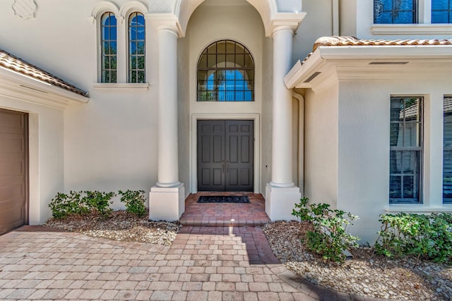 16106 Rosecroft Ter, Delray Beach, FL 33446 - view of exterior entry featuring stucco siding and a tile roof