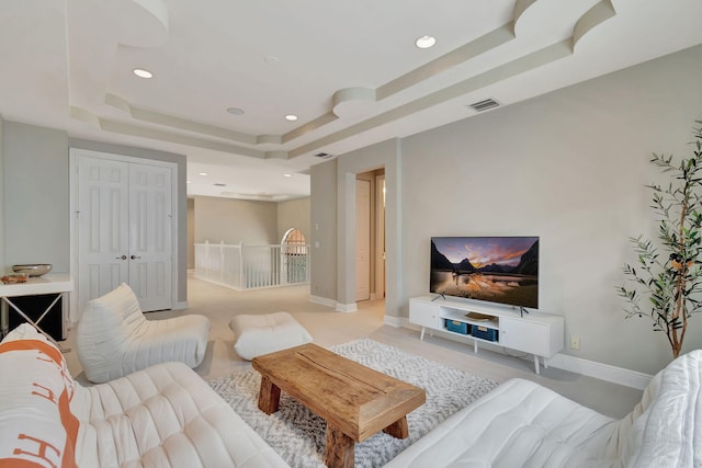 living room featuring a tray ceiling