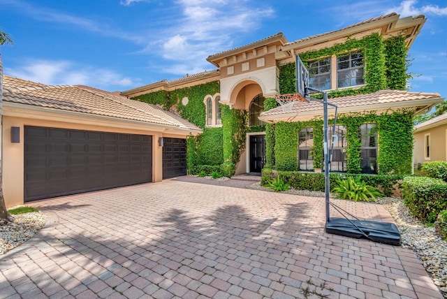 mediterranean / spanish-style home featuring a garage