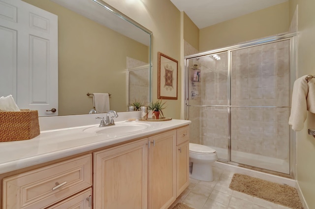 bathroom featuring tile patterned flooring, vanity, toilet, and a shower with shower door