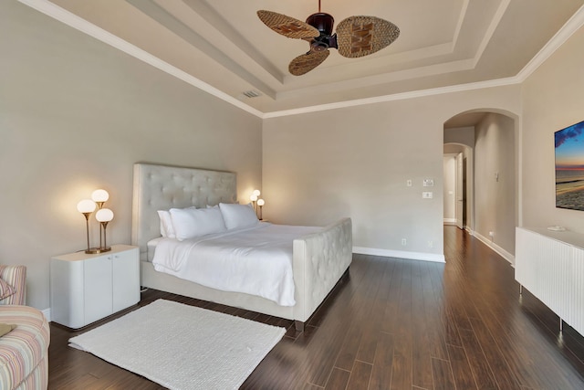 bedroom featuring crown molding, ceiling fan, a tray ceiling, and dark hardwood / wood-style flooring