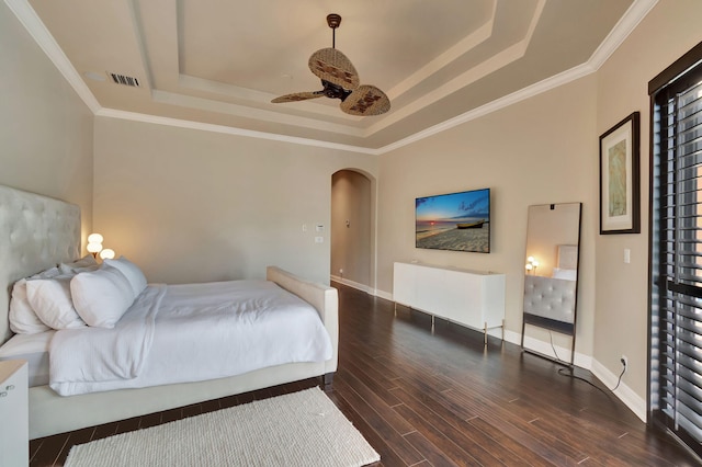 bedroom with ornamental molding, a raised ceiling, ceiling fan, and dark hardwood / wood-style floors