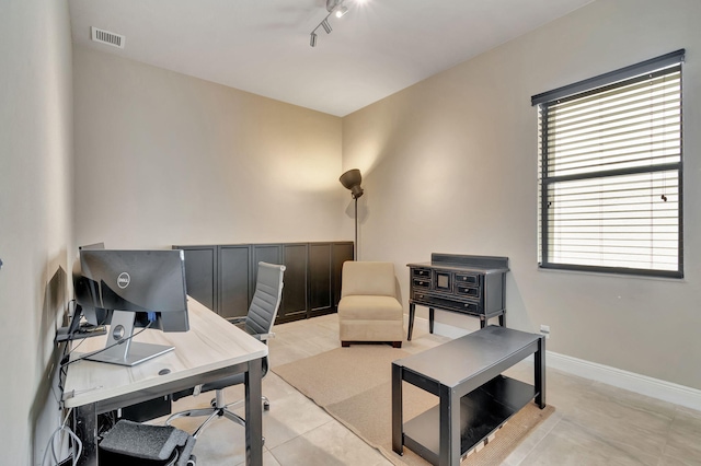 tiled office featuring track lighting