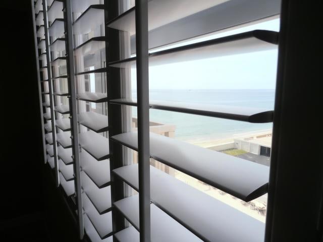 interior space with a water view and a beach view