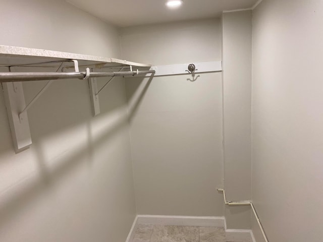 spacious closet featuring light tile patterned floors