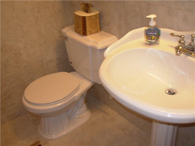 bathroom with tile patterned flooring, toilet, and sink