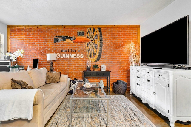 living room with brick wall and a textured ceiling