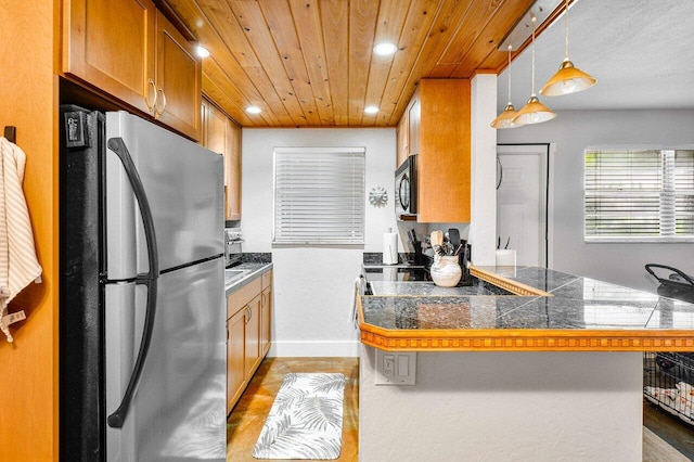 kitchen with pendant lighting, kitchen peninsula, stainless steel refrigerator, and light hardwood / wood-style floors