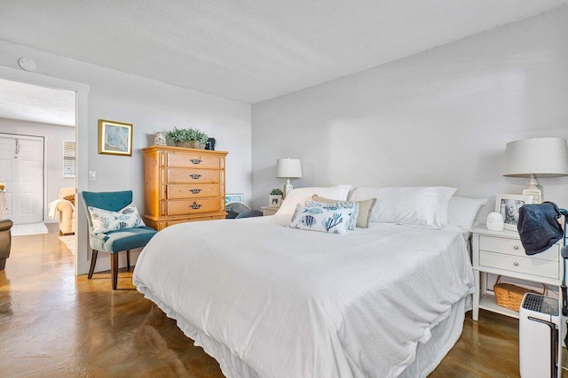 bedroom with a textured ceiling and dark hardwood / wood-style flooring