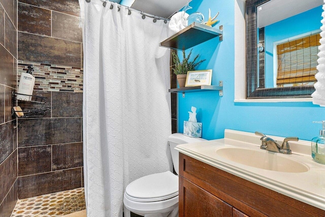 bathroom with vanity, toilet, and walk in shower