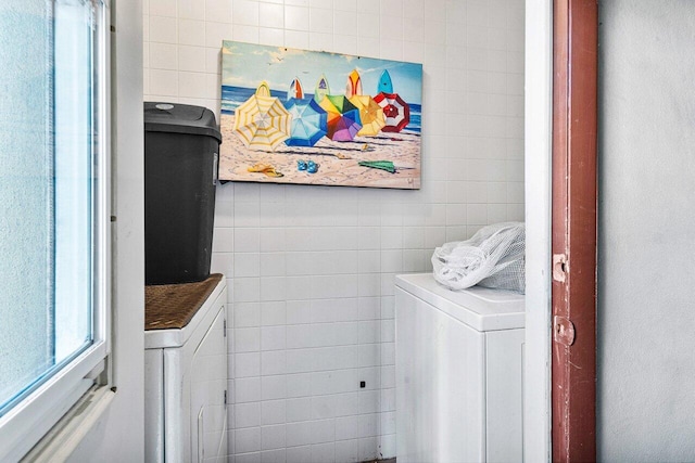 clothes washing area with washer and clothes dryer