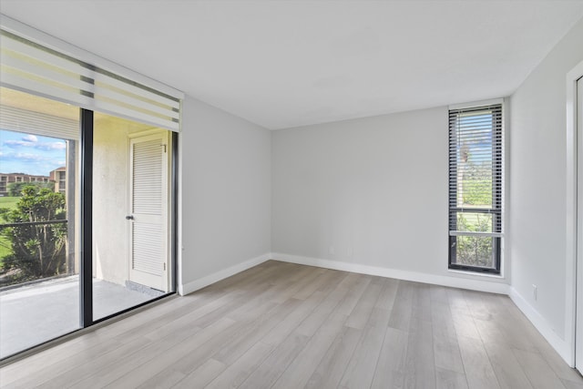 empty room featuring plenty of natural light and light wood-type flooring