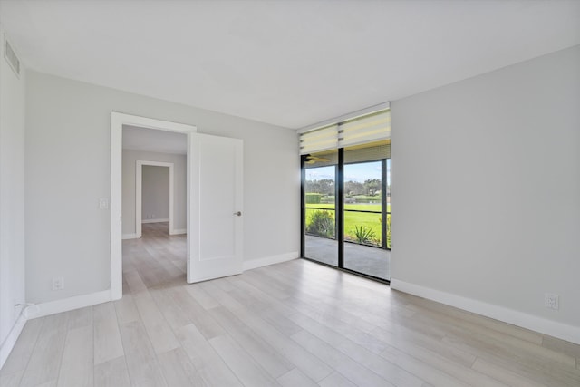 unfurnished room with light hardwood / wood-style flooring