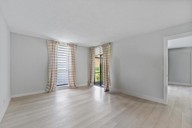 unfurnished room with light hardwood / wood-style flooring