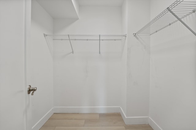 spacious closet featuring hardwood / wood-style flooring