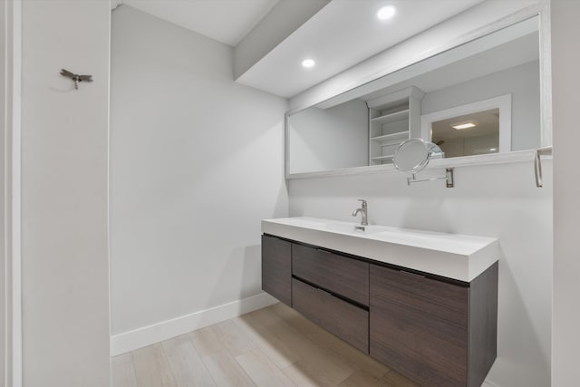 bathroom with hardwood / wood-style flooring and vanity