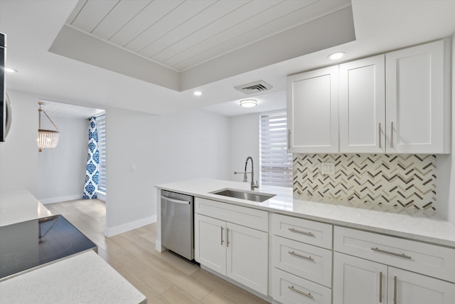 kitchen featuring white cabinets, backsplash, dishwasher, light hardwood / wood-style floors, and sink