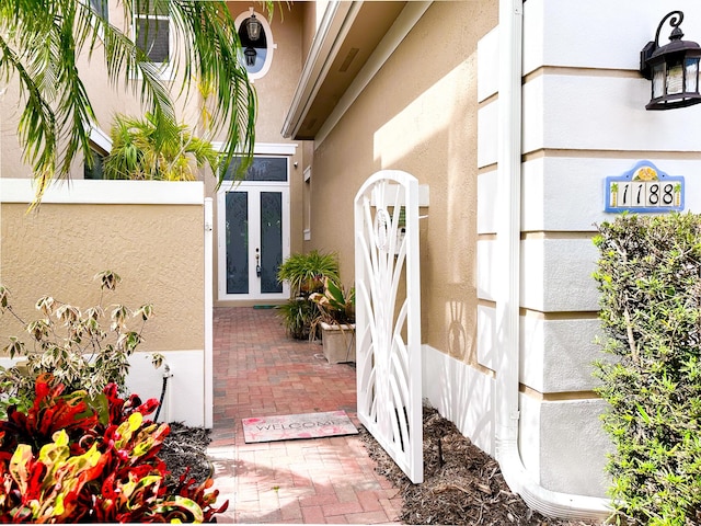 entrance to property featuring stucco siding