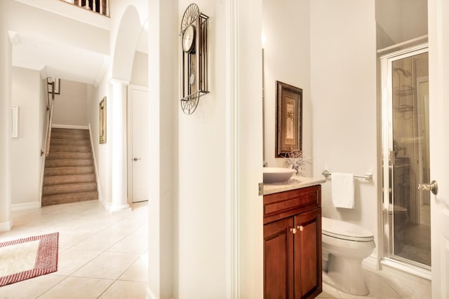 full bath featuring toilet, a stall shower, vanity, ornate columns, and tile patterned floors