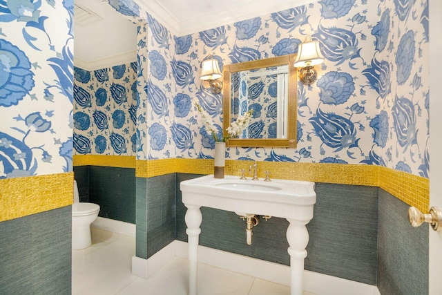 bathroom with ornamental molding, tile patterned flooring, and toilet