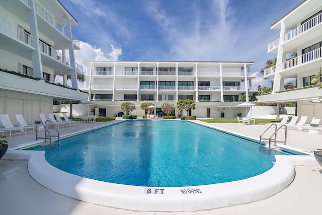 view of swimming pool with a patio