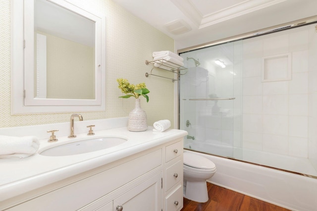 2275 S Ocean Boulevard 307 & 308, Palm Beach, FL 33480 - bathroom with vanity, toilet, enclosed tub / shower combo, wood finished floors, and ornamental molding