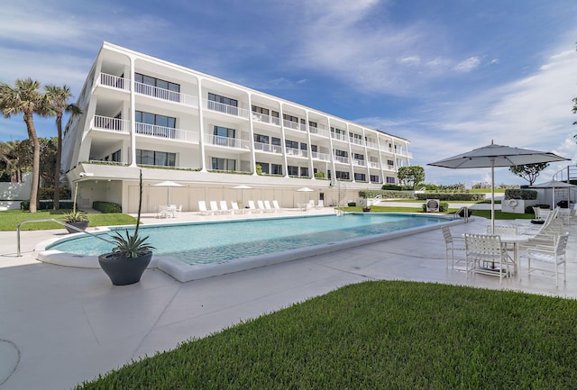 view of swimming pool with a lawn and a patio area