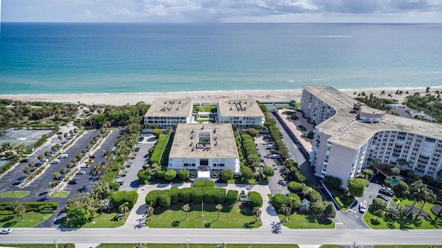 birds eye view of property with a beach view and a water view