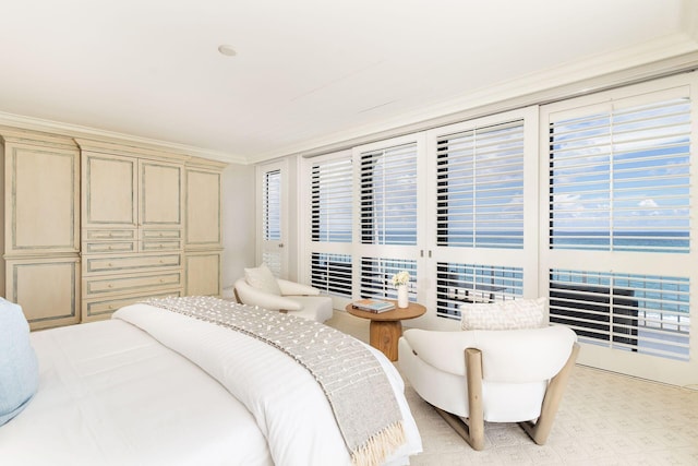 bedroom featuring multiple windows, crown molding, and access to exterior