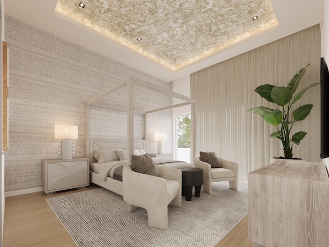 bedroom featuring a tray ceiling and wood finished floors