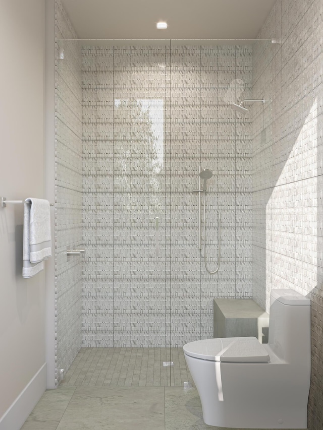 bathroom with a shower stall and toilet