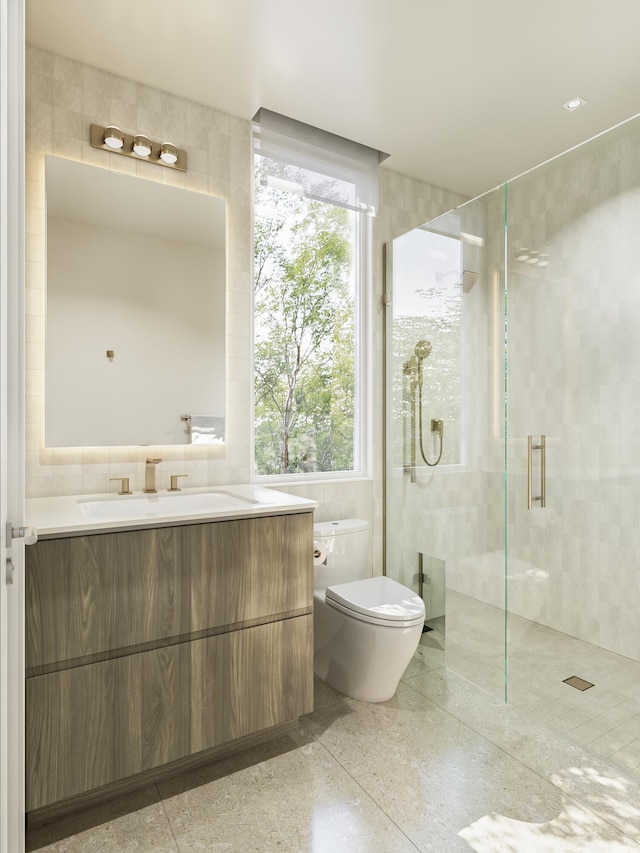 bathroom featuring toilet, tile walls, a stall shower, and vanity