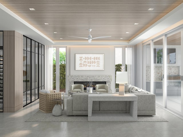 living room featuring recessed lighting, a high end fireplace, ceiling fan, a raised ceiling, and wooden ceiling