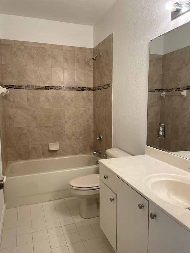 5071 SE Mariner Garden Cir, Stuart, FL 34997 - bathroom featuring toilet, tile patterned flooring, vanity, shower / bathing tub combination, and a textured wall
