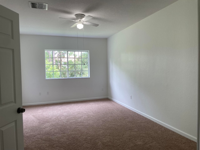 carpeted empty room with ceiling fan