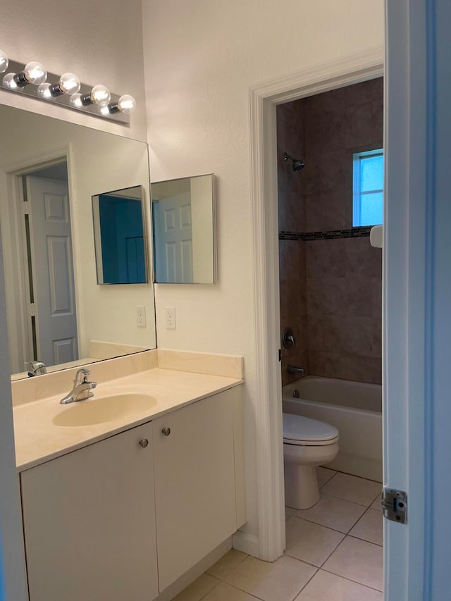 full bathroom with tile patterned floors, tiled shower / bath combo, toilet, and vanity