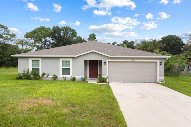 ranch-style house with a garage and a front lawn